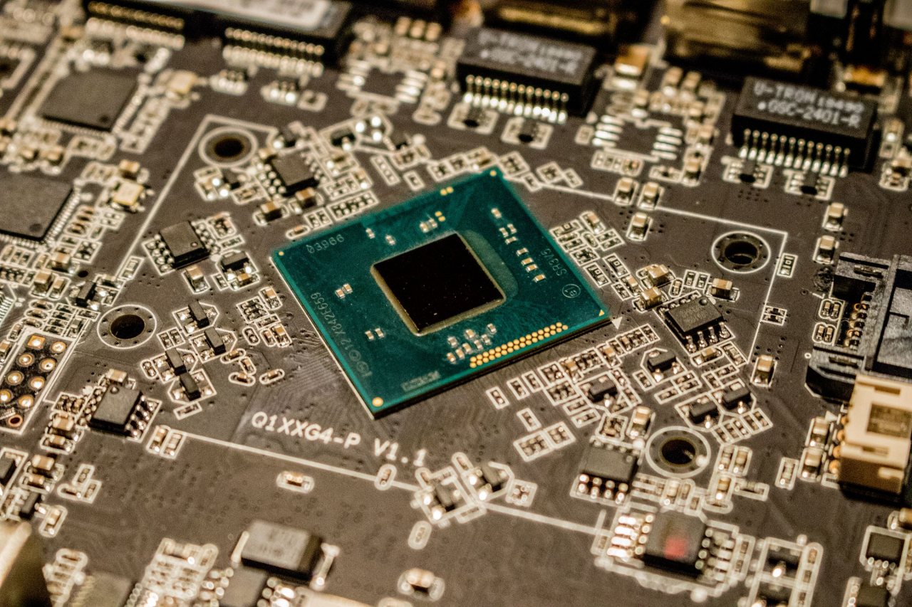 Close-up of a mobile electronics circuit board on an assembly line
